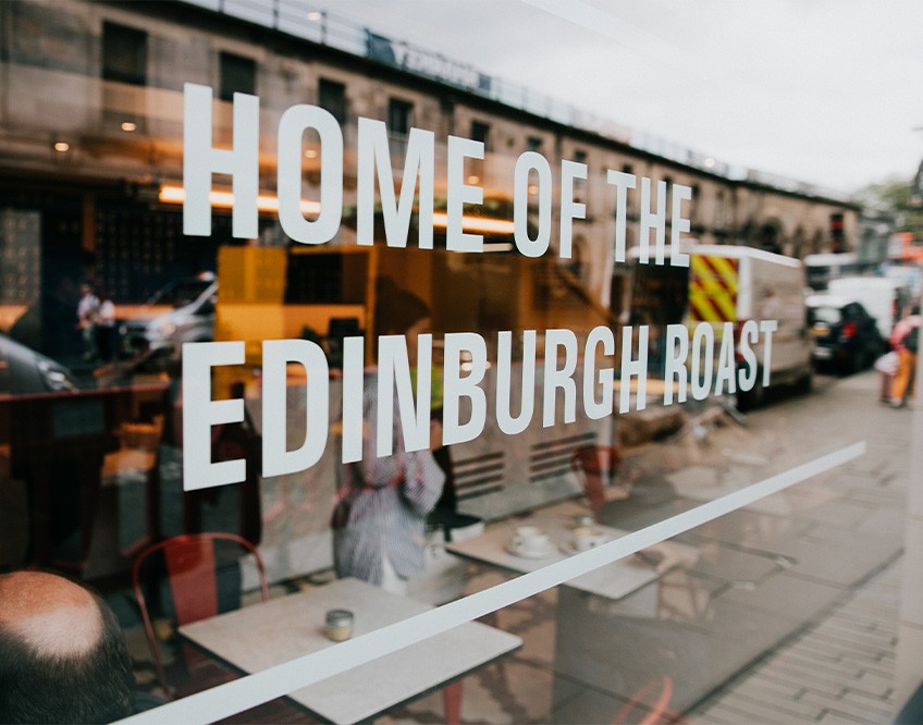 Image of the Gordon St Coffee - Edinburgh sign in the window of the coffee house venue