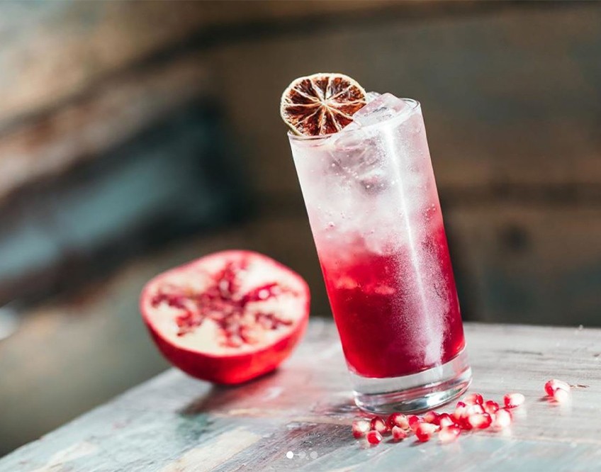 Image of the inside of The Tipsy Bird bar showing an Ann St Cooler drink on a table 