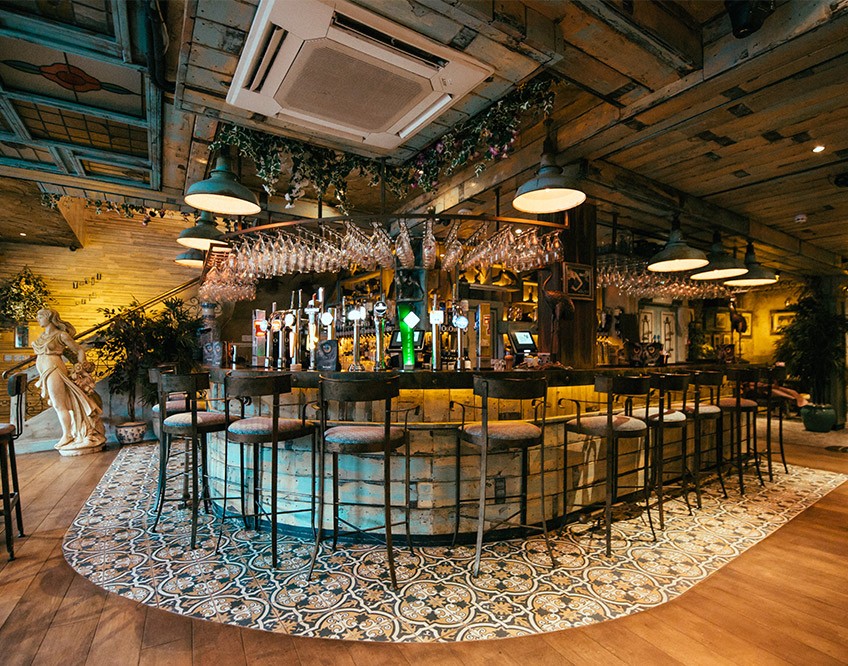 Image of the inside of The Tipsy Bird bar with stools at the bar