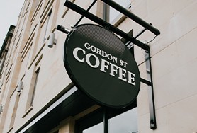 Image of the Gordon St Coffee - Edinburgh sign outside the coffee house venue