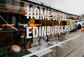 Image of the Gordon St Coffee - Edinburgh sign in the window of the coffee house venue